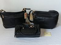 Front view of two Stone Mountain leather purses and one ili pocketbook, all black and new with tags