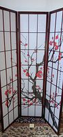 Front view of the three-panel Asian room divider showing red floral branches across the panels