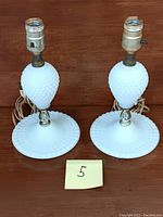 Pair of vintage milk glass lamps with hobnail pattern, showing full height and width.