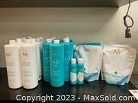 Front view of hair colour products including 30 and 40 volume developers, smaller bottles, and Blonde Voyage powder pouches