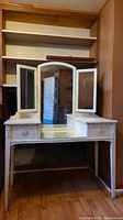 Full front view of antique painted vanity table with tri-fold mirror and two small drawers