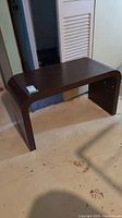 Full view of the rectangular coffee table with curved sides, showing overall shape and color.