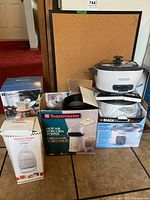 Full lot with popcorn popper, Euro chopper, rice cookers, gadget organizer box, and cork board.