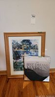 Framed impressionist print by Berthe Morisot standing against a wall next to a wrapped square canvas print.