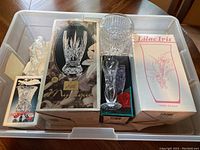 Top view showing 8 boxed and unboxed glass vases including clear and cut crystal designs, some in original packaging