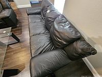 Front view of couch showing three cushions and armrests.
