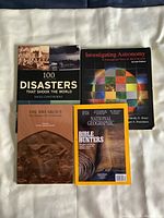 Top view of the four reference books stacked and laid out showing titles and front covers.