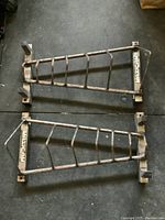 Top view of two Maxicam steel weight racks on gym flooring showing frame construction and angled slots.