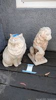 Photo of both feline statues next to each other showing size and details