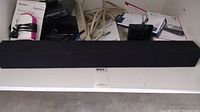 Speaker bar shown front and back with input connectors visible