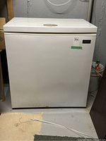 Front view of the Kenmore deep freeze compact freezer showing the white body, hinged top lid, and some dirt marks on lower front.