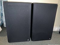 Pair of large vintage Telefunken speakers with black fabric front covers, standing side by side on carpeted floor.