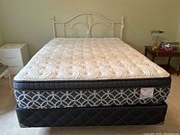 Full view of assembled bed frame with mattress and box spring.
