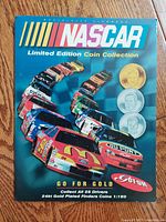Front cover of the NASCAR Limited Edition Coin Collection album showing racing cars and example coin images