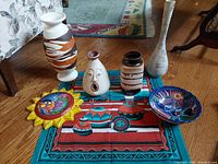 Shot of all pottery items arranged with textile cover beneath to show the southwestern themed art and items