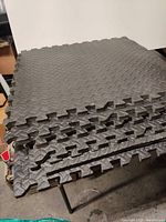 Stack of 6 grey foam workout tiles showing puzzle interlocking edges and thickness.