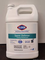 Photo of white 1-gallon jug labeled Clorox Healthcare Spore Defense Cleaner Disinfectant showing front label with product claims and branding.