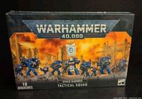 Front of the box showing Warhammer 40,000 branding and image of 10 Space Marines Tactical Squad miniatures in blue armor with weapons and banner.