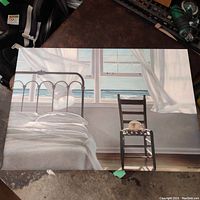 Front-facing photo of the large print showing the beach house interior with bed and chair by a window with ocean view.