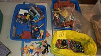 Blue bin with loose toy parts, trading cards, Popeye cutout and accessories