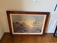 Front view of framed canvas print showing lighthouse scene at sunset