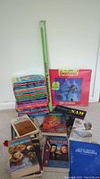 Photo showing the majority of the lot: stack of about 20 Goosebumps paperback books, 1994 Goosebumps calendar, rolled Scooby Doo poster, and other book titles including Star Wars and Shakespeare.