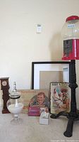 Photo showing full lot with gumball machine, reproduction signs, table clock, glass jar, and figurines.