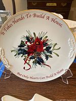Front of Lenox porcelain bowl showing cardinal, pine cone, and ribbon motif with quote on rim.