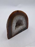 Angle shot of polished front showing crystals and agate bands