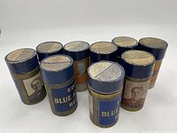 Ten antique Edison Blue Amberol cylinder records in original labeled storage tubes arranged in a group showing front side with photo labels.