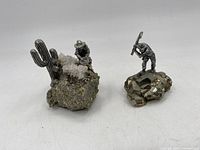 Both rock and pewter ornaments shown together, giving overall perspective and relative size.