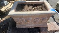View of the full planter from the front, showing overall shape, dimensions, and base structure, placed on a dolly (dolly not included).
