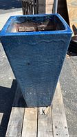 Front view of the tall square blue glazed ceramic planter showing overall shape and finish.
