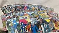 Full view of the 30 Robotech: The Macross Saga comic books fanned out showing varied cover artworks featuring characters and robots.