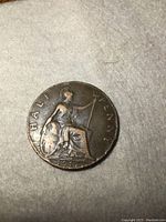 Obverse of 1917 British Half Penny showing seated Britannia with trident and shield and the date.