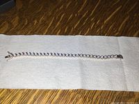 Full-length view of bracelet laid flat on fabric