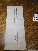 Full length of the sterling silver chain necklace laid flat on gray cloth showing the chain design and length.