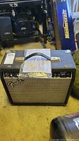 Front view of Fender Frontman 25R guitar amplifier showing speaker grille and Fender logo.