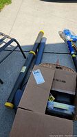 Two rod tubes and blue soft case on concrete