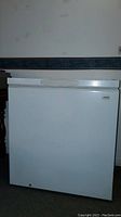 Front view of the Kenmore white chest freezer showing the lid, brand label and overall condition.