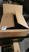 Opened cardboard box with flaps partially up revealing contents inside