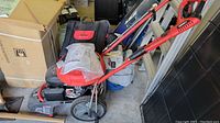 Full view of power washer showing frame, wheels, and handle