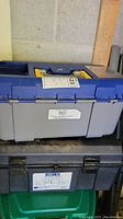 Tool boxes stacked on shelf, shows overall condition and labels