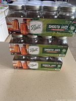 Three boxes of Ball Smooth Jars stacked, each box labeled as 12 Pint (16 oz) jars with lids and bands, total of 36 jars.