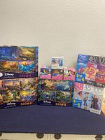 Lot of various new Disney puzzles including boxed 4-pack 500-piece puzzles and smaller individual puzzles.