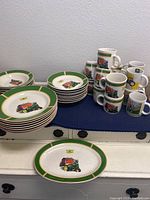 Full set of Gibson John Deere dinnerware arranged showing plates stacked and mugs grouped. Displays green border and tractor designs.