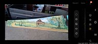 Full view of the saw blade showing the landscape oil painting with barn and trees.