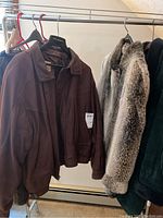 Brown leather men's coat with panel design, visible zipper and collar