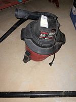 Craftsman wet dry vacuum with visible label showing 2.5 peak HP and 8 gallon capacity. Black and red color.