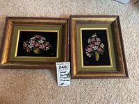 Two framed velvet floral pictures on beige carpet. Multi-tone wood frames with gold and olive green trim.